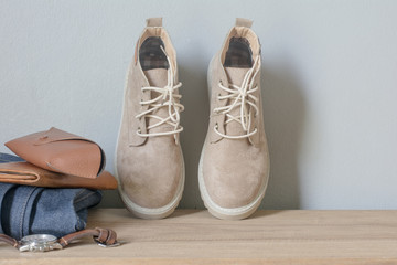 Close up vintage leather shoes accessory. Woman casual outfits with accessories on rustic wood background,Accessories with brown leather shoes on wooden table