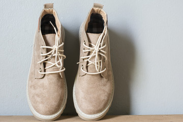 Close up vintage leather shoes accessory. Woman casual outfits with accessories on rustic wood background,Accessories with brown leather shoes on wooden table