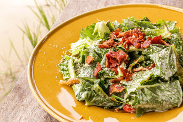 Caesar salad on wooden table