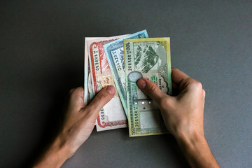 Hands holding nepalese currency (banknotes).