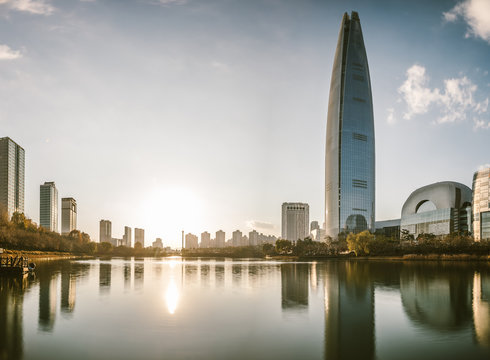 skyline of seoul reflecting in big pond at sunset, south korea