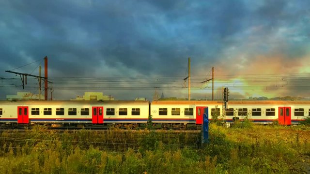 Cinemagraph train and dramatic sky with dark clouds with endless looping motion. 