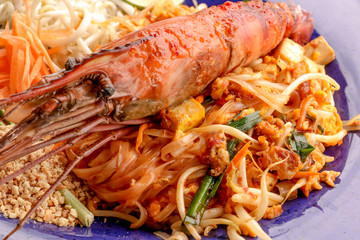 Hot Pad thai with shrimp on wooden table