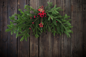 christmas fir branchs on old dark wooden background