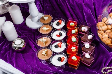 Zelfklevend Fotobehang Candy bar. Wedding reception table with sweets, candies, dessert, meringues, fruit tart, cupcakes, muffins, cakes, eclairs © Jukov studio