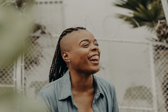 Joyful woman genuinely laughing toward camera