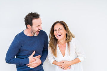 Beautiful middle age couple in love over isolated background Smiling and laughing hard out loud because funny crazy joke. Happy expression. - obrazy, fototapety, plakaty