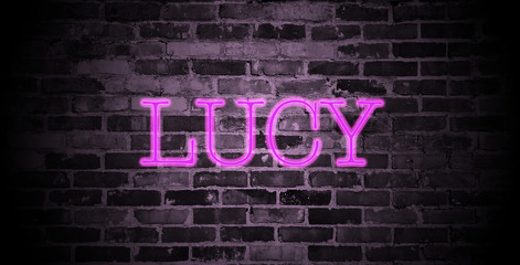 first name Lucy in pink neon on brick wall