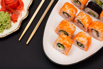 Uramaki California. Sushi rolls and pickled ginger and wasabi.