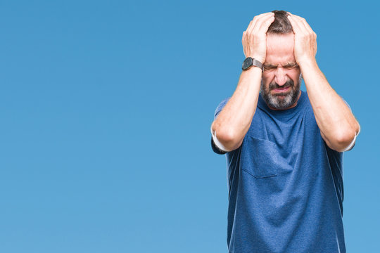 Middle age hoary senior man over isolated background suffering from headache desperate and stressed because pain and migraine. Hands on head.