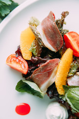 Sliced beef and marbled beef steak with garnish. Restaurant dish for the menu.