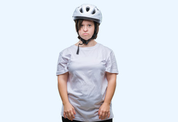 Young adult cyclist woman with down syndrome wearing safety helmet over isolated background with serious expression on face. Simple and natural looking at the camera.