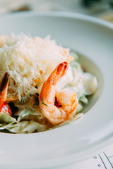 The Caesar salad and the classic shrimp. Restaurant dishes with a beautiful serving.