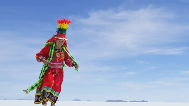 Traditional Bolivian dance performed proudly by Indigenous South American female on Salar de Uyuni Salt flats wearing traditional costume 