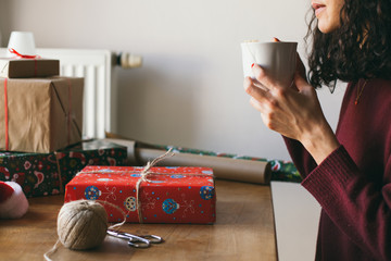 Woman wrapping Christmas presents indoor