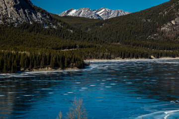 A sheen of ice still covers Barrier Lake, Bow Valley Provincial Park, Alberta, Canada