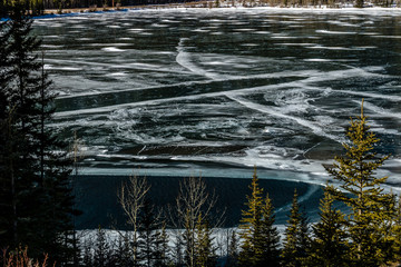 A sheen of ice still covers Barrier Lake, Bow Valley Provincial Park, Alberta, Canada