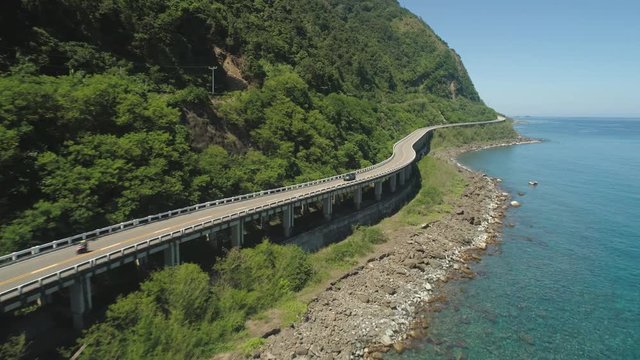 Aerial view of Patapat viaduct in the coast of Pagudpud, Ilocos Norte. Highway with bridge by coast sea near the mountains. Philippines, Luzon.