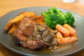 sous vide chicken chop with potato wedges and baby carrot broccolli