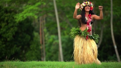Single beautiful young Polynesian female hula dancer in Paradise entertaining in traditional costume barefoot outdoor French Polynesia South Pacific