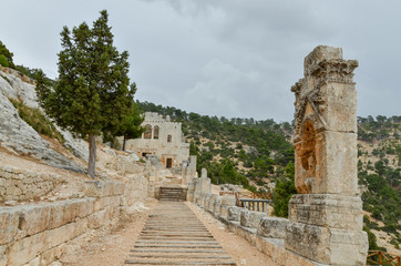 Fototapeta na wymiar Colonnaded Walkway leading to the East Church in Alahan Monastery in the mountains of Isauria Mut, Mersin province, Turkey