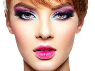 Beautiful woman with bright vivid purple make-up.