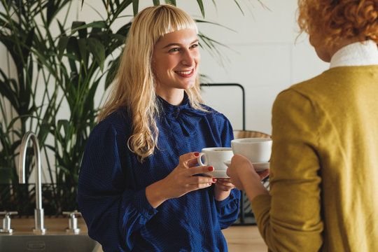 Female Co-Workers Chatting Over Coffee