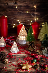 Christmas background with decorations on wooden table with warm lighting.
