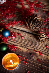 Christmas background with decorations on wooden table with warm lighting.