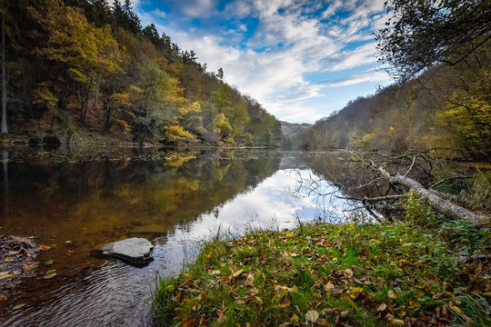 Stunning reflection and view of the Ourthe at autumn time of year Ardennes Belgium
