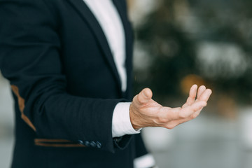 Hands of a businessman to design with a neutral photon. Okay, high five, palms and a successful man.