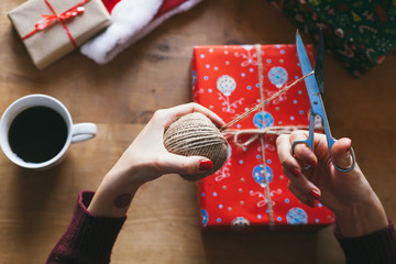 Woman wrapping Christmas presents indoor