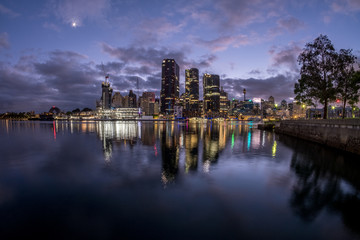 Fototapeta premium Sydney City under a crescent moon and dawn clouds