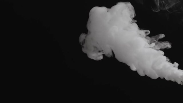 Slow motion closeup vapor stream from right on black background