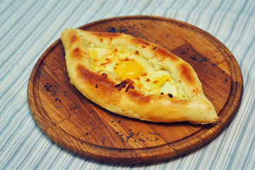Traditional khachapuri in Adjara on a wooden stand