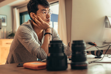 Photographer thinking while editing pictures
