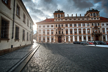 Fototapeta premium Toskansky Palace at Hradčany Square in Prague, Czech Republic with sunset light and sun flares