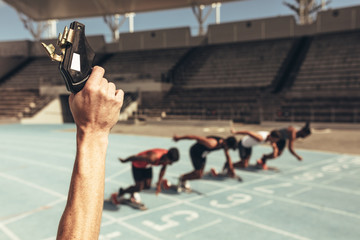 Athletes starting off for a race on a running track