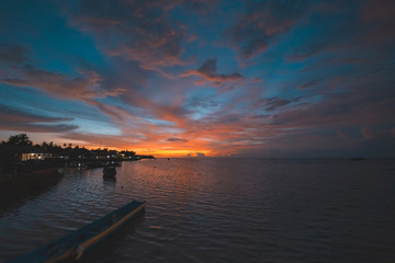 Sunset dramatic sky on tropical desert beach, coral reef reflection no people, travel destination, Indonesia Wakatobi