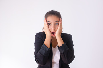 Screaming young buyer shocked from sale and holding head in hands. Portrait of surprised manager yelling at camera. Isolated on white. Surprise concept