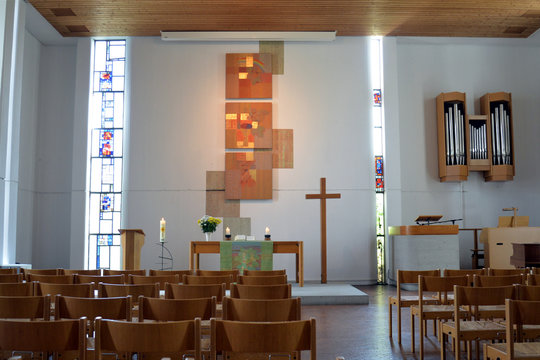 Paul-Gerhardt-Kirche in Plochingen with interior (nave), altar, crucifix and  artistic formed windows