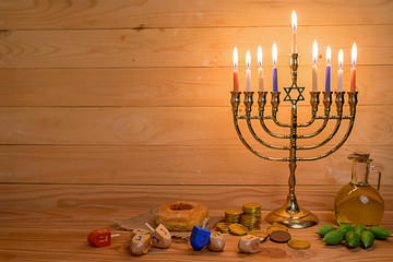 Jewish holiday hanukkah celebration with menorah (traditional candelabra), wooden dreidels...