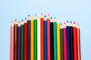 colorful pencil on blue paper background