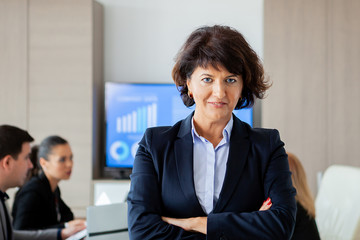 Middle aged business woman in conference room. Woman suit.