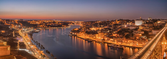 Fototapeta premium view of the city of porto in portugal from the bridge dom luis at night panoramic shoot