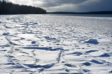 Snow-covered ice on lake Uvildy in late autumn. South Ural, Chelyabinsk region, Russia