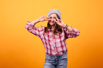 Happy kid having a good time in studio on yellow background. Photoshoot vibe.