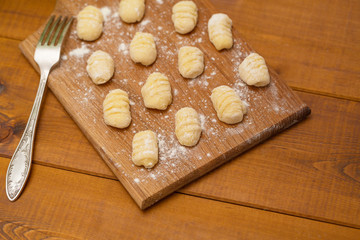 Fototapeta na wymiar Uncooked homemade gnocchi on cutting board
