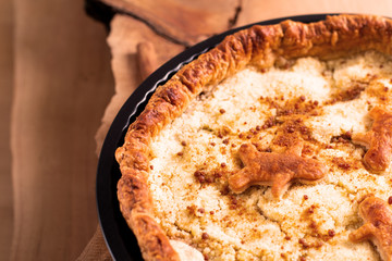 Food concept fresh baked homemade Apple crumble pie in pan on wooden background with copy space