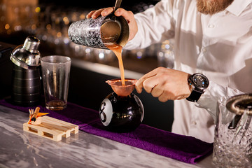 Bartender bartender is pouring a drink. Alcoholic drink